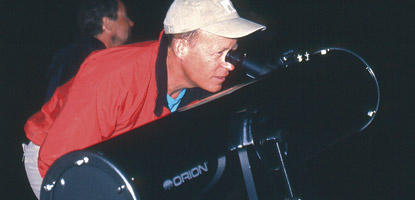 Visitors look through a telescope at an evening program in the Needles District
