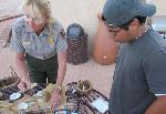 A ranger demonstrates daily life of the Fremont Culture using a replica of a prehistoric drill.