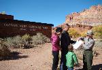 A ranger gives directions to visitors outside of the visitor center.