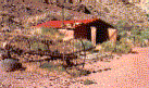 Blacksmith Shop with a hay rake in foreground