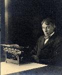 Carl sitting behind typewriter