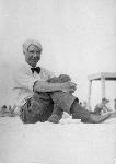 Carl Sandburg sitting on the beach