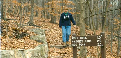 A hiker enjoying park trails in autumn.