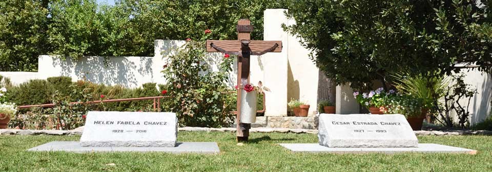 The graves of Cesar and Helen Chavez surrounded by green grass