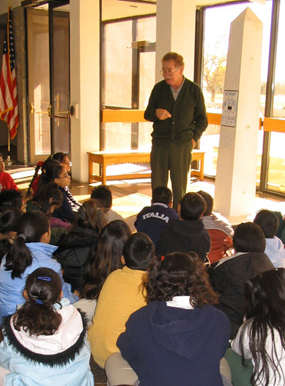 A ranger talks with students during an on-site visit.