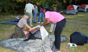Park ranger Nancy Walther shows first time campers how to set up a tent.