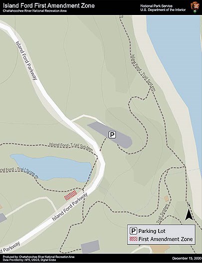 First Amendment Zone is the grassy area along the access road near the pond.