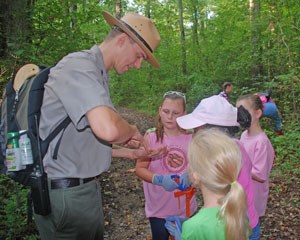 A park ranger works with young people at Chickamauga Battlefield