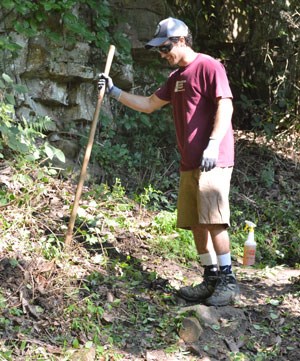 A volunteers helps clear a trail on Lookout Mountain