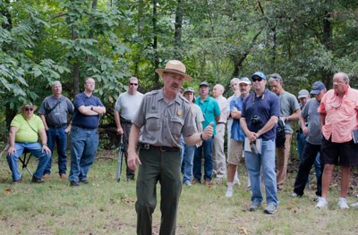 Park Historian Jim Ogden leads a hike with a crowd of visitors
