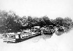 Four boats dock along the canal