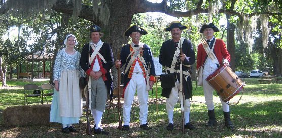 Volunteers and staff in Revolutionary War period costume.