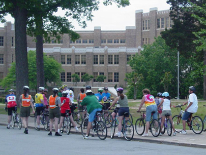 Participants listen to rangers conducting a safety message as they prepare for a bicycle tour.