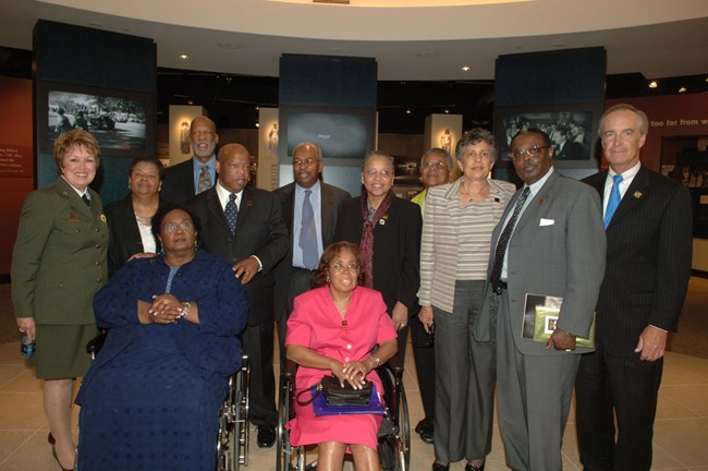 The Little Rock Nine stand in the park's new visitor center with NPS Director Mary Bomar, Interior Secretary Kempthorne, and Congressman Lewis.
