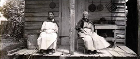 Creole women sitting on their porch in the Cane River region. (Historic photo)