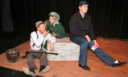 Clara Barton actress helping two actors, one dressed as a wounded Confederate soldier and one as a wounded Union soldier.
