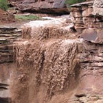 Flash flood pouring off cliff face