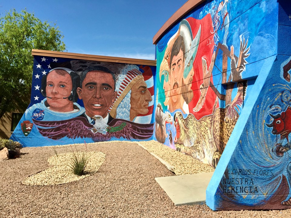 Mural panel showing faces from left to right of White astronaut, Barack Obama, and a Native American leader. An eagle with wings spread and arrows in one talon and olive branches in another below the three faces.