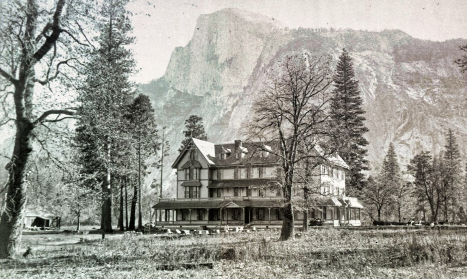 A hotel building with cliff behind.