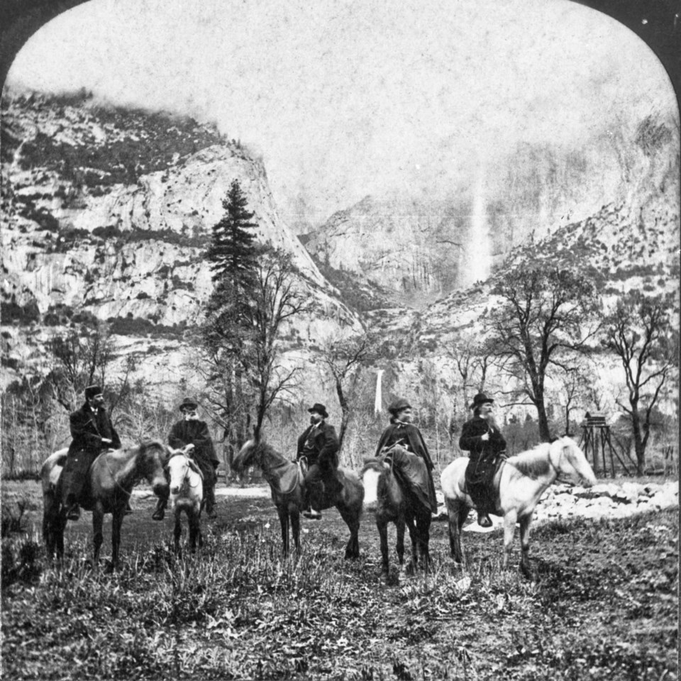 Group of men on horseback with waterfalls in background