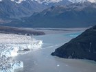 a large tidewater glacier nearly closing off a fjord