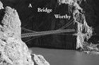 Bridge attached to two rocky cliffs spanning a river, text reads 