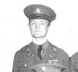 Pixelated black and white photo of a uniformed person.
