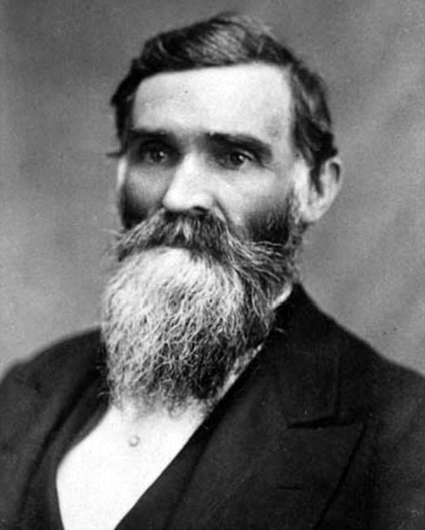 black and white photo of a bearded man in a suit