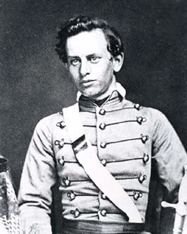 Black and white photograph of a man win a military dress uniform with a strap across his chest