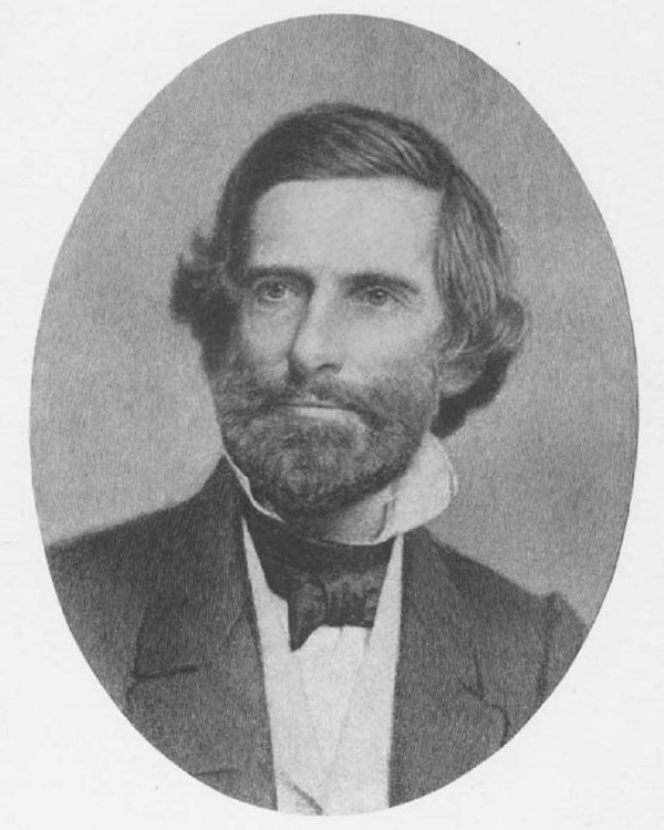 Drawing of a White man with dark hair and a dark beard wearing a dark suit with a white shirt.