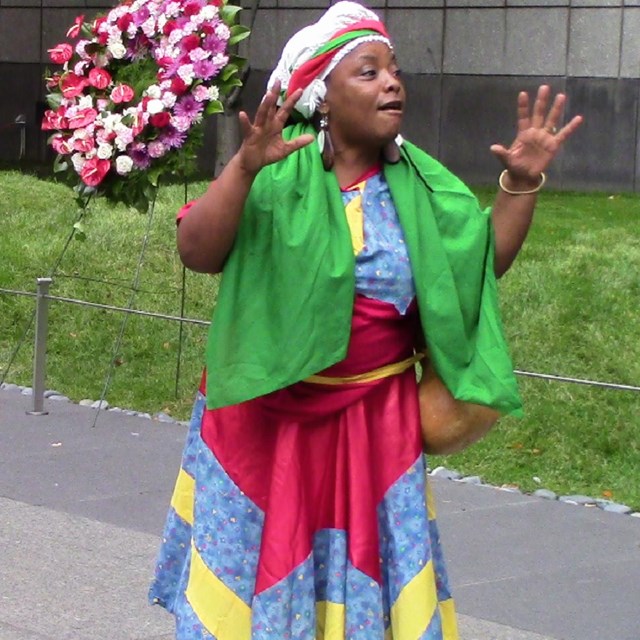 A woman paying tribute to the ancestors at the monument.