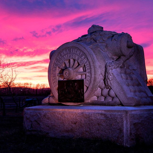 The monument to Pennsylvania Independent Battery C in the Peach Orchard with a brilliant sunset.