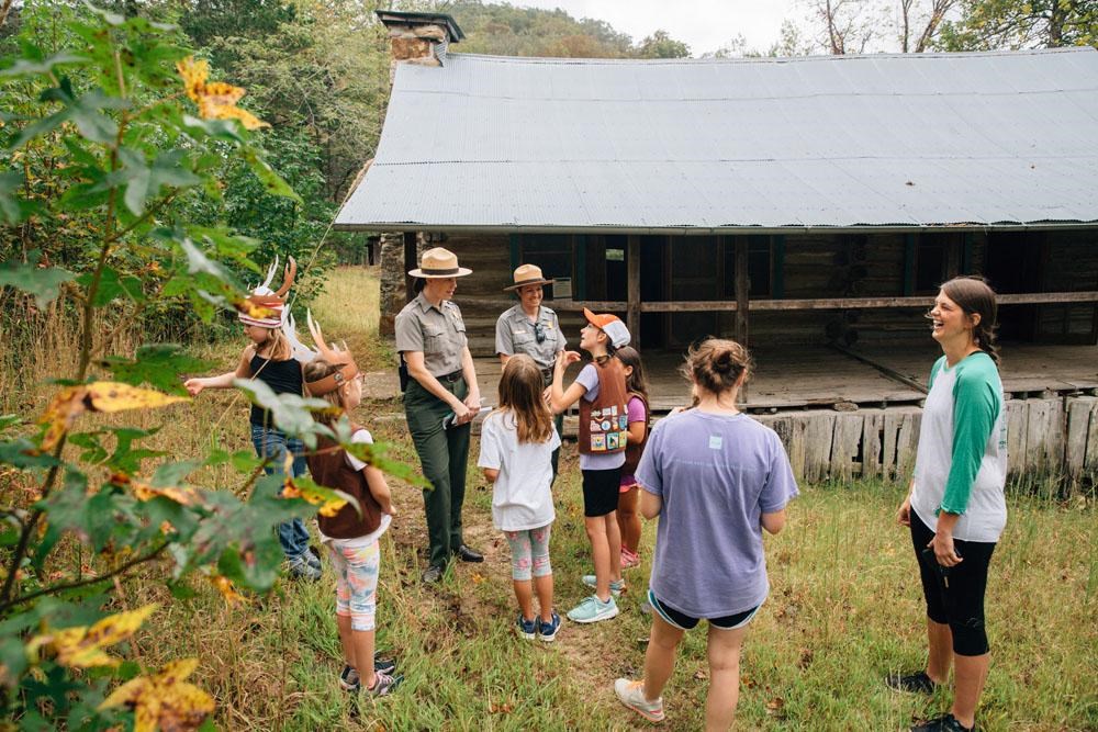 Park rangers guide a group of Girl Scouts at the Beaver Jim Villines Farmstead