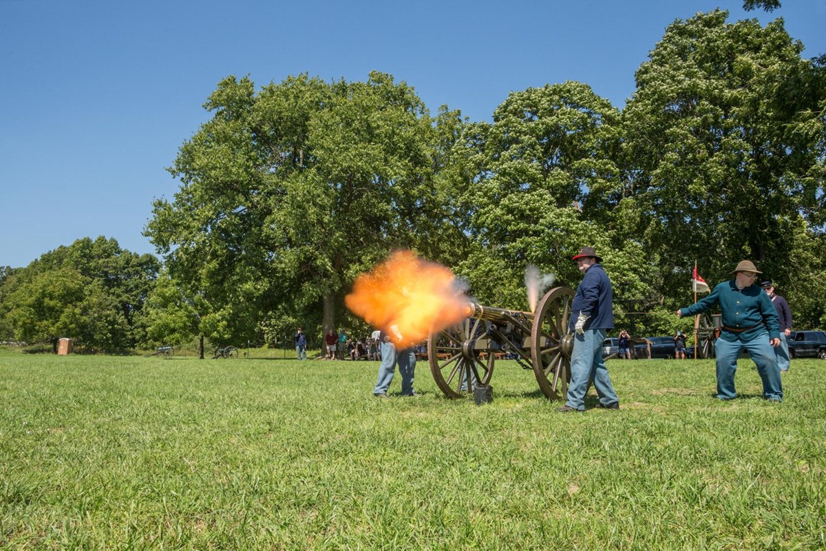 Artillery Crew firing cannon with burst of yellow fire