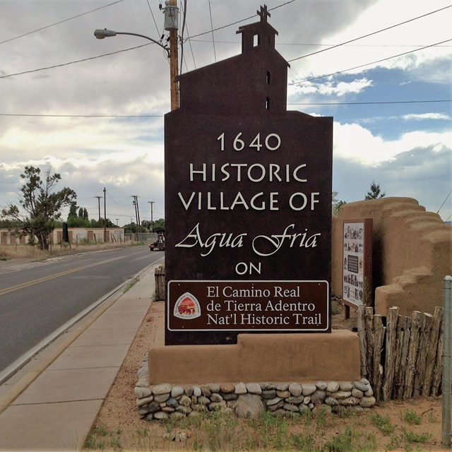 highway sign that says historic village of agua fria