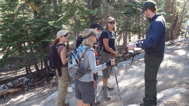 A survey is being administered along a trail in Yosemite.
