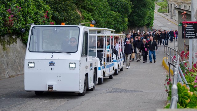 Tram carrying visitors up a steep slope. 