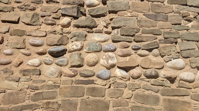 Walls made of cobblestones and sandstone bricks at Aztec Ruins. 