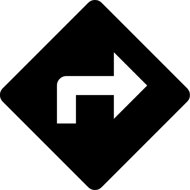 black and white right-hand arrow on road sign