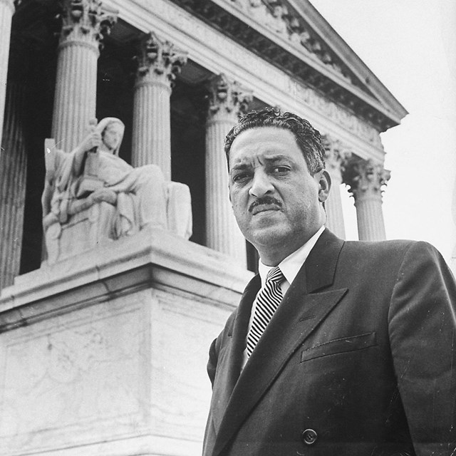 Thurgood Marshall stands before the U.S. Supreme Court Building.