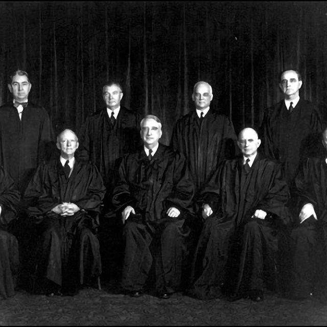 Nine justices sit in their judicial robes