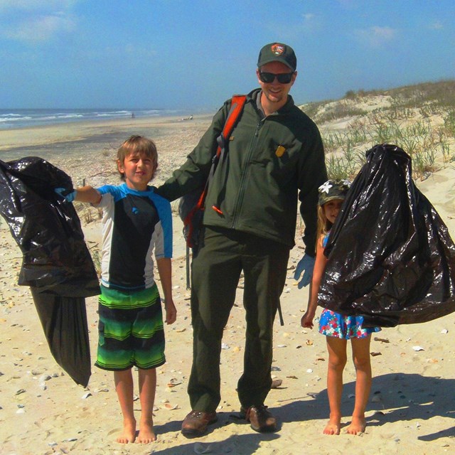 Ranger leading a beach clean-up program