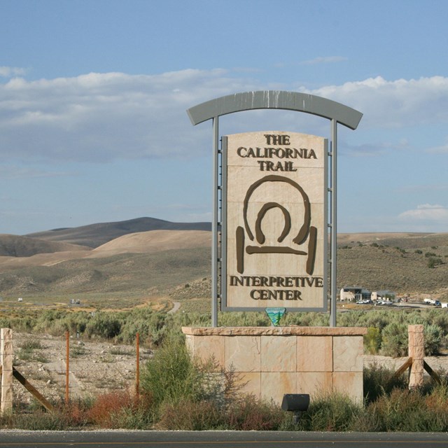 A large road sign with a wagon cut-out design, announcing the California Trail Interpretive Center