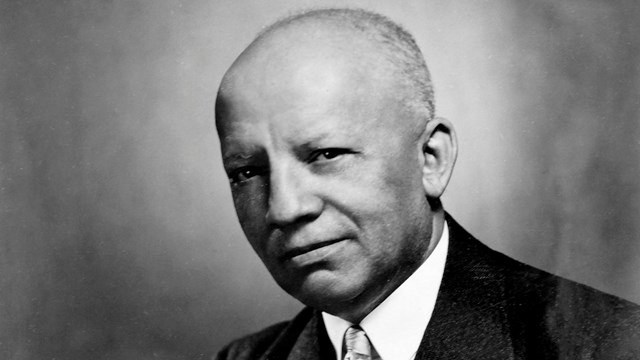 A black-and-white portrait of Carter G. Woodson
