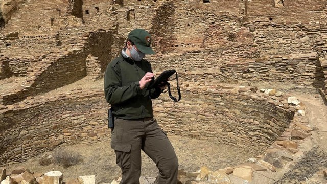 An archaeologist surveying at Pueblo Bonito. 