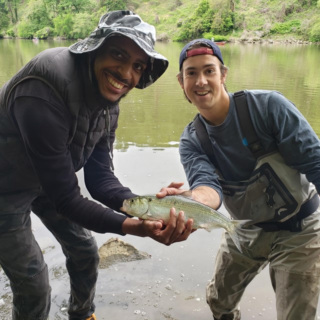 Two men holding a fish