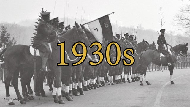 African American Cavalry soldiers on horseback saluting during a ceremony at West Point