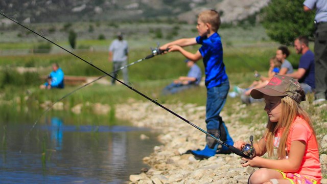 kids fishing from the bank at Castle Rocks Pond.