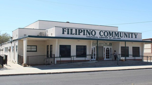 Picture of one story long white building with Filipino Community written across the top