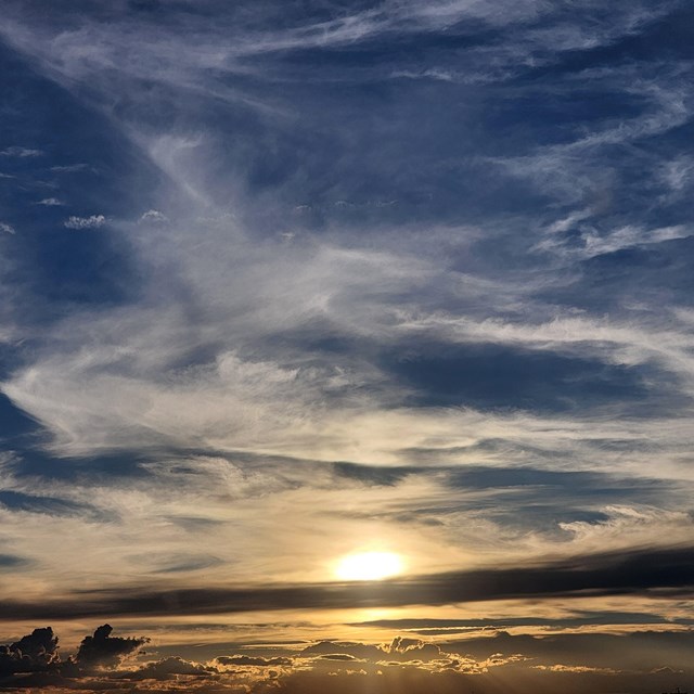 Setting sun illuminates cirrus clouds. 